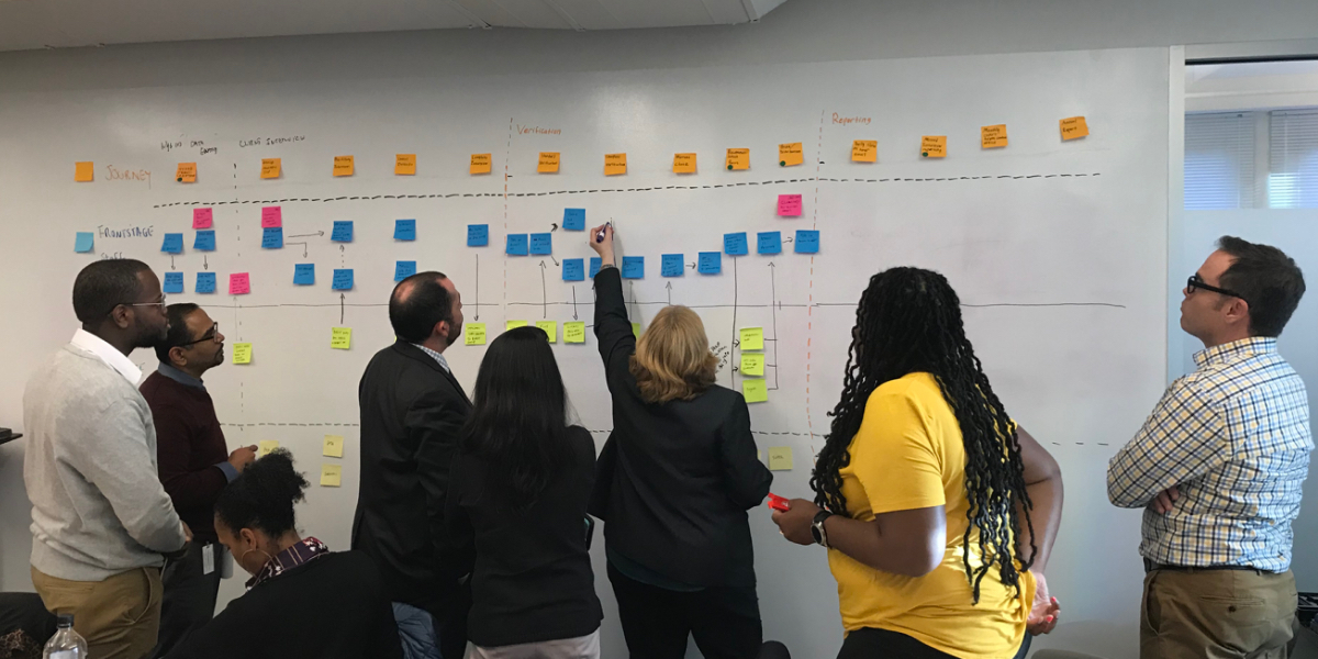 A woman writes on a whiteboard with a marker